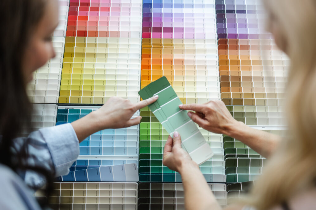 person looking at paint chips in home hardware