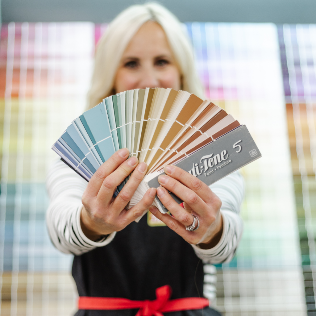 woman fanning paint colour swatches at the paint store 