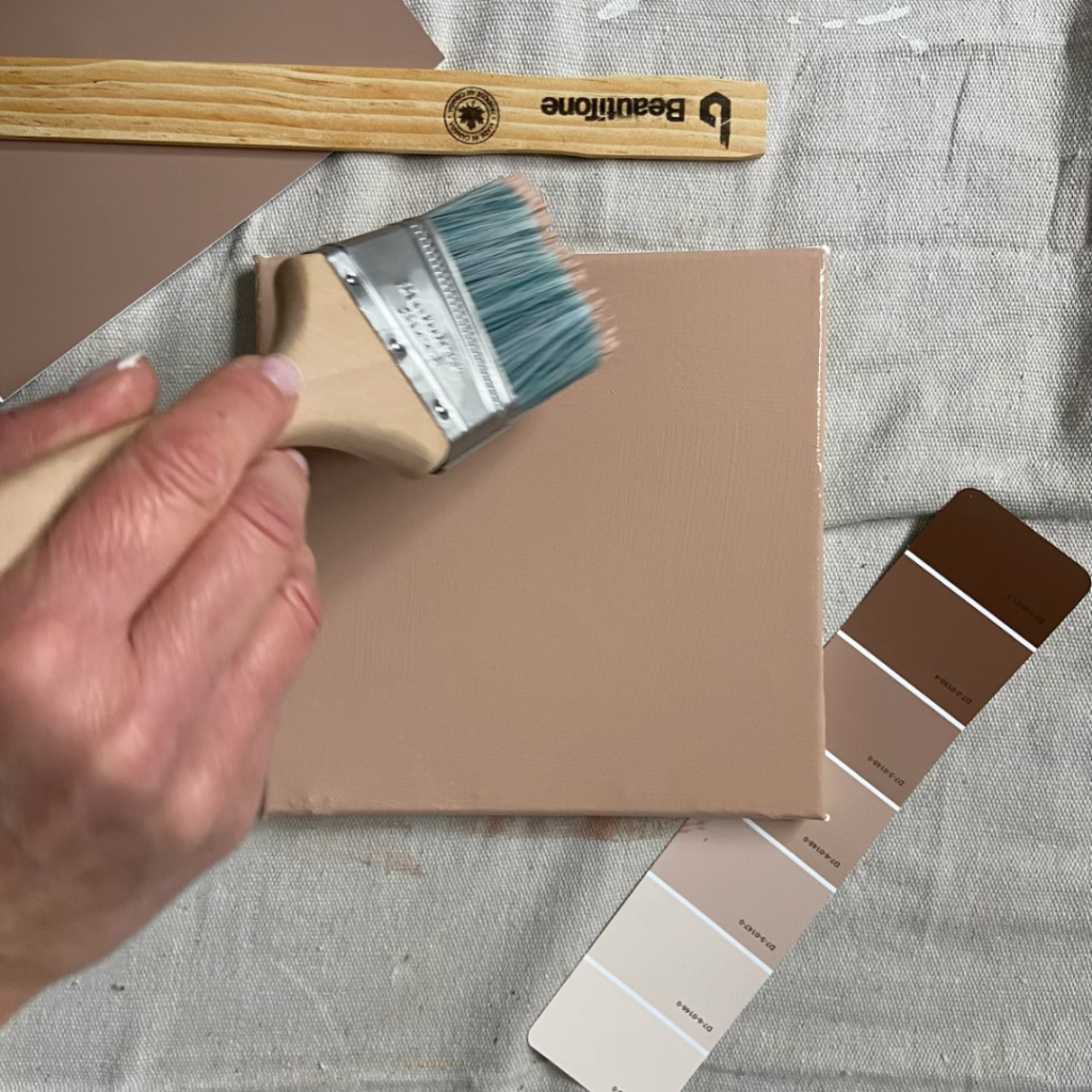 large paint sample board with paint brush