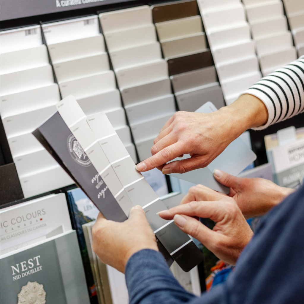 client looking at grey paint colour swatches with paint colour consultant