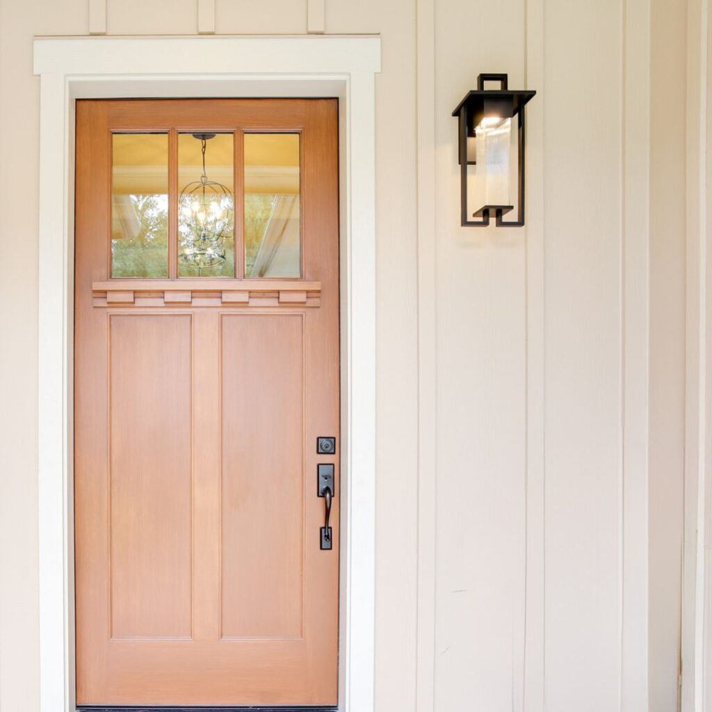 terracotta orange door with antique hardware and white trim