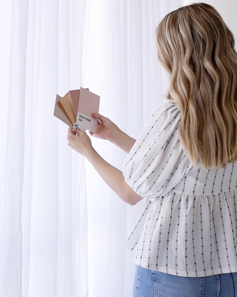 woman holding paint chips 