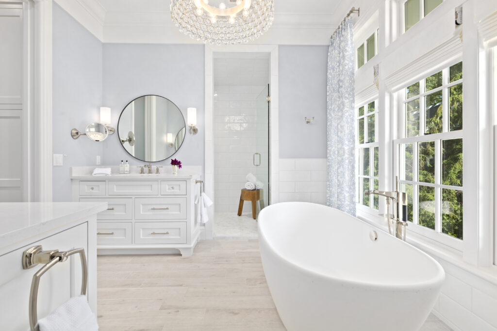 All white bathroom timeless with beautiful double hung windows above the tub