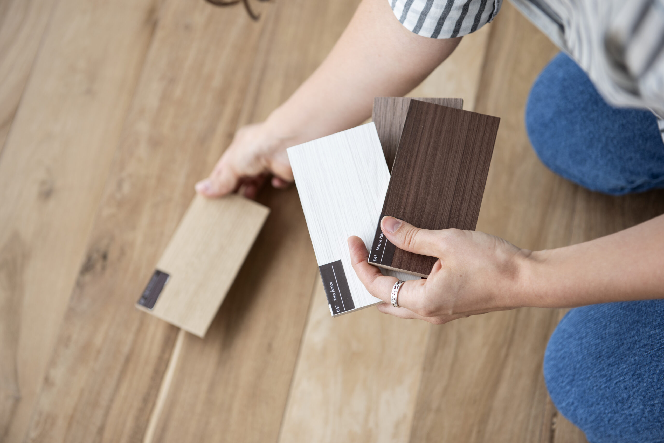 Woman testing hard wood flooring samples