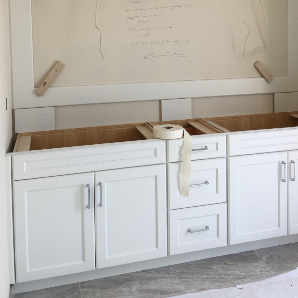 partially built white bathroom vanity, chrome hardware